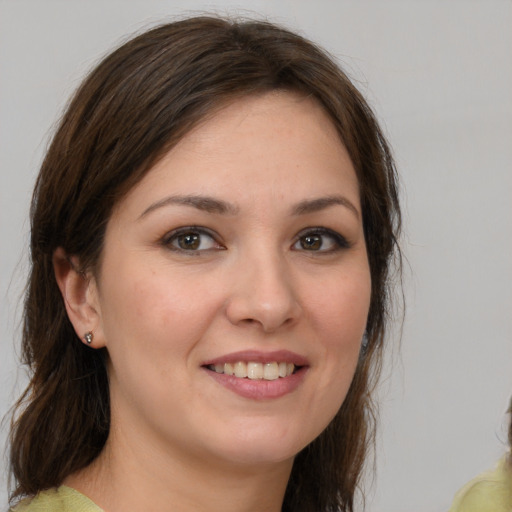 Joyful white young-adult female with medium  brown hair and brown eyes