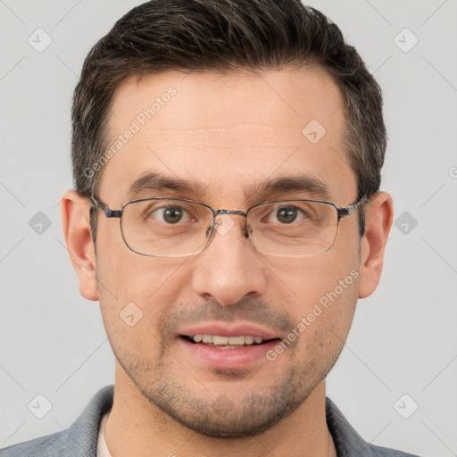 Joyful white adult male with short  brown hair and brown eyes