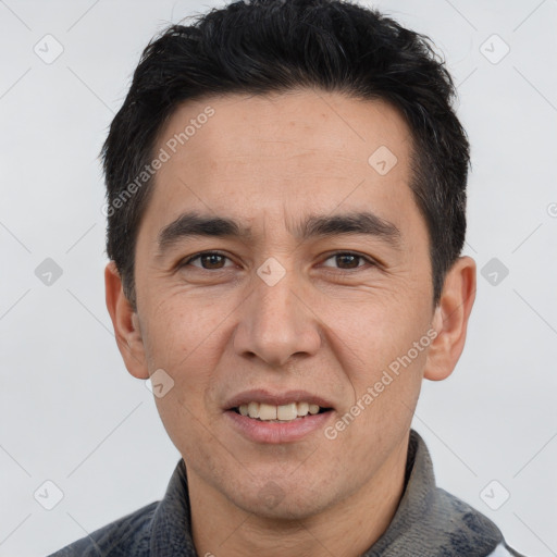 Joyful white adult male with short  black hair and brown eyes