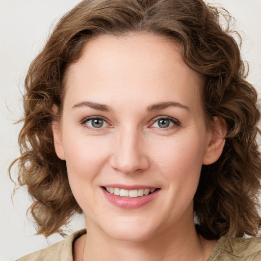 Joyful white young-adult female with medium  brown hair and green eyes