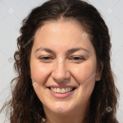 Joyful white adult female with long  brown hair and brown eyes