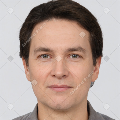 Joyful white adult male with short  brown hair and grey eyes