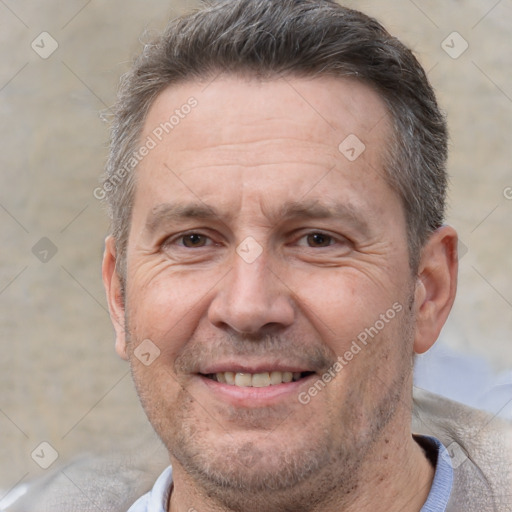 Joyful white adult male with short  brown hair and brown eyes