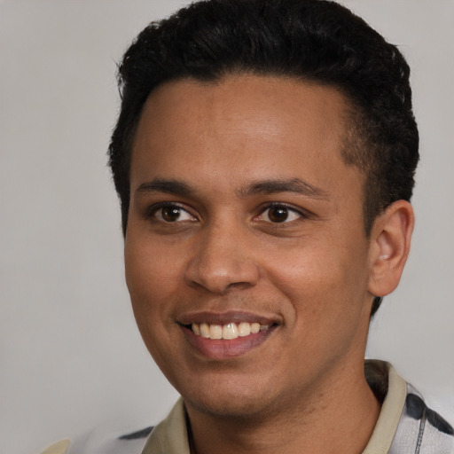 Joyful latino young-adult male with short  black hair and brown eyes