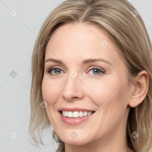 Joyful white adult female with medium  brown hair and grey eyes