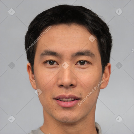 Joyful asian young-adult male with short  black hair and brown eyes