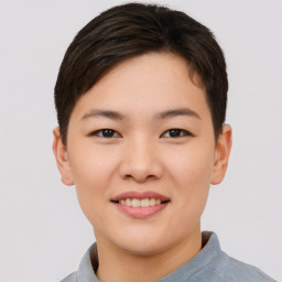 Joyful asian young-adult female with short  brown hair and brown eyes