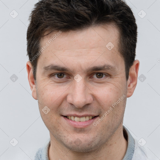 Joyful white adult male with short  brown hair and brown eyes