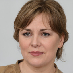 Joyful white adult female with medium  brown hair and grey eyes