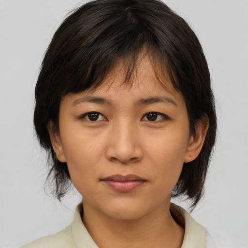 Joyful asian young-adult female with medium  brown hair and brown eyes