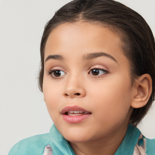 Joyful white child female with medium  brown hair and brown eyes