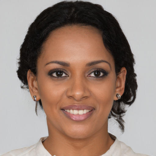Joyful black young-adult female with medium  brown hair and brown eyes