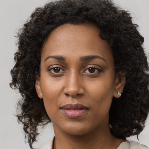 Neutral black young-adult female with medium  brown hair and brown eyes