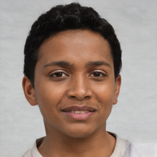 Joyful black young-adult female with short  black hair and brown eyes