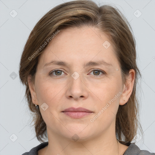 Joyful white adult female with medium  brown hair and grey eyes