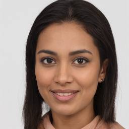 Joyful latino young-adult female with long  brown hair and brown eyes