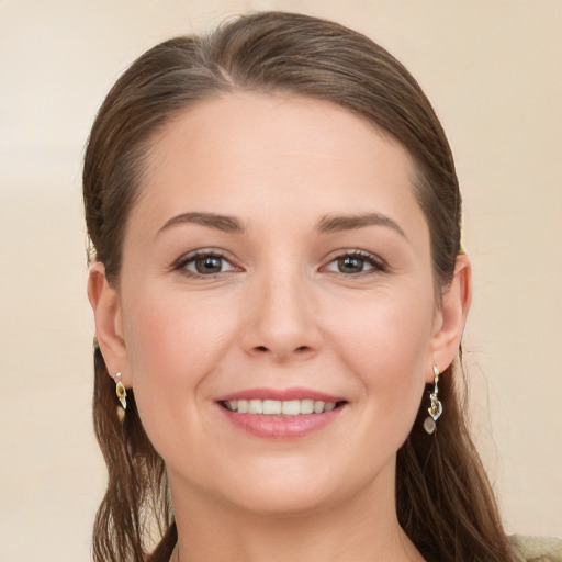 Joyful white young-adult female with long  brown hair and grey eyes