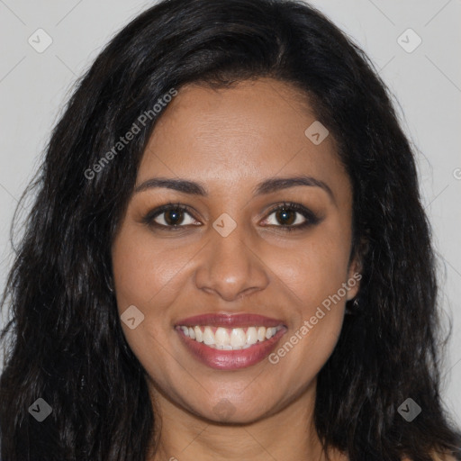 Joyful black young-adult female with long  brown hair and brown eyes