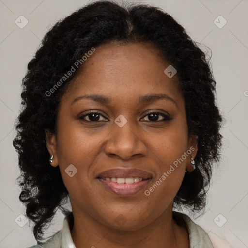 Joyful black young-adult female with long  brown hair and brown eyes