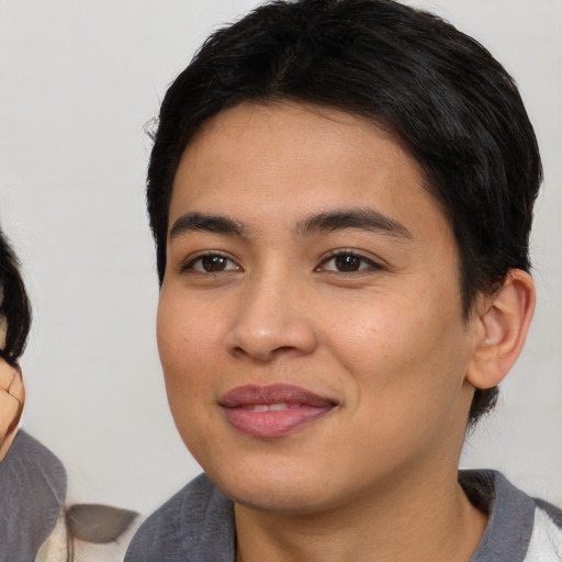 Joyful latino young-adult female with medium  black hair and brown eyes