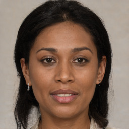 Joyful latino young-adult female with medium  brown hair and brown eyes