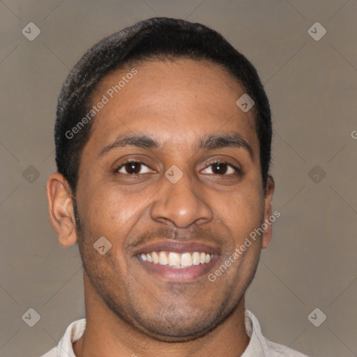 Joyful latino young-adult male with short  brown hair and brown eyes