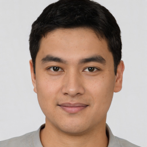 Joyful asian young-adult male with short  brown hair and brown eyes