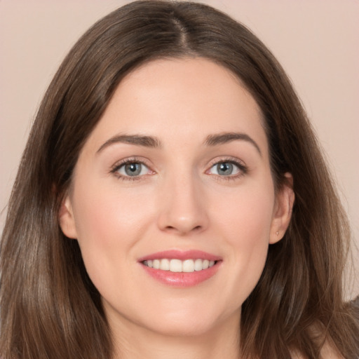 Joyful white young-adult female with long  brown hair and grey eyes