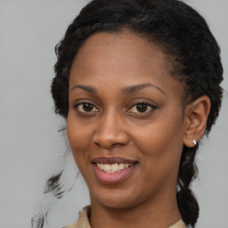 Joyful black young-adult female with long  brown hair and brown eyes