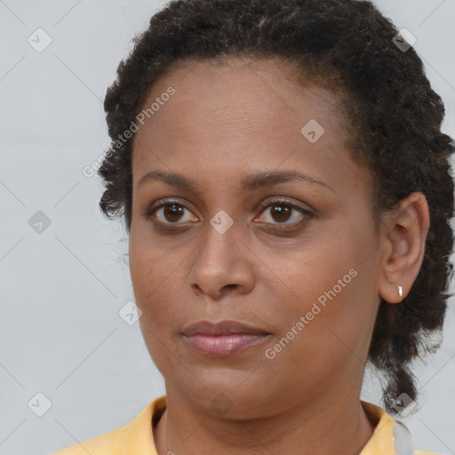 Joyful black young-adult female with short  brown hair and brown eyes