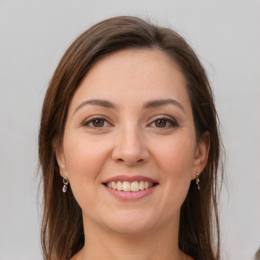 Joyful white young-adult female with long  brown hair and grey eyes