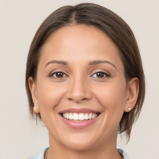 Joyful white young-adult female with medium  brown hair and brown eyes