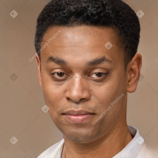 Joyful black young-adult male with short  black hair and brown eyes