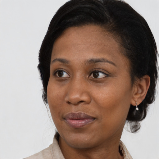 Joyful black young-adult female with medium  brown hair and brown eyes