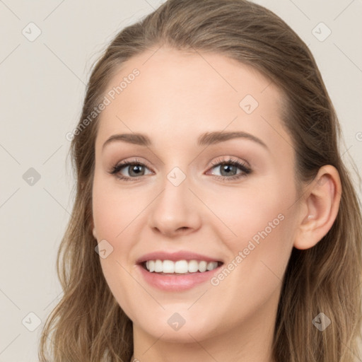 Joyful white young-adult female with long  brown hair and blue eyes