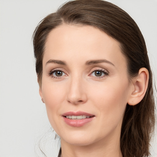 Joyful white young-adult female with medium  brown hair and grey eyes