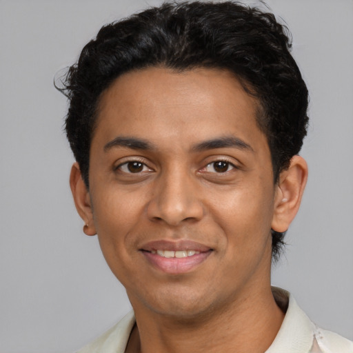 Joyful latino adult male with short  black hair and brown eyes