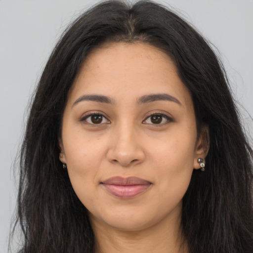 Joyful latino young-adult female with long  brown hair and brown eyes