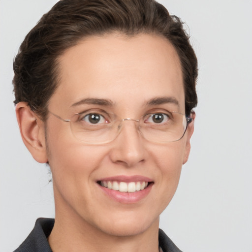 Joyful white adult female with short  brown hair and grey eyes