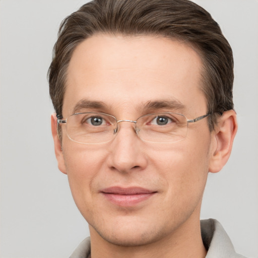 Joyful white adult male with short  brown hair and grey eyes