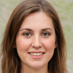 Joyful white young-adult female with long  brown hair and green eyes