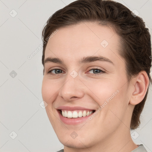 Joyful white young-adult female with short  brown hair and grey eyes