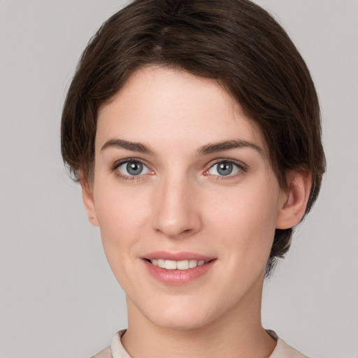 Joyful white young-adult female with short  brown hair and grey eyes