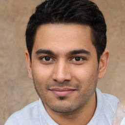 Joyful latino young-adult male with short  black hair and brown eyes