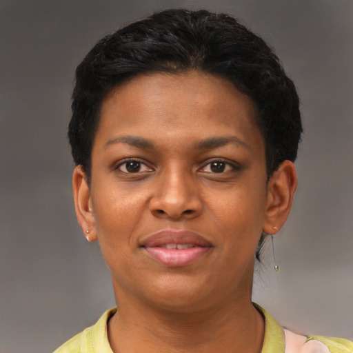 Joyful black young-adult female with short  black hair and brown eyes