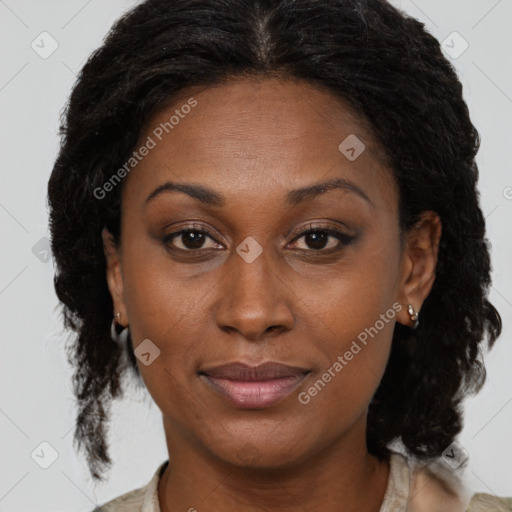 Joyful black adult female with medium  brown hair and brown eyes