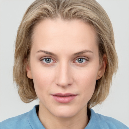 Joyful white young-adult female with medium  brown hair and blue eyes