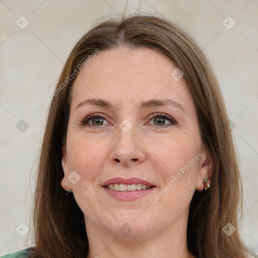 Joyful white adult female with medium  brown hair and green eyes