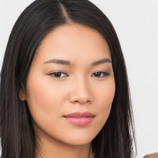 Joyful asian young-adult female with long  brown hair and brown eyes