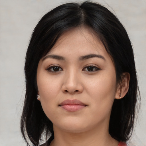 Joyful white young-adult female with medium  black hair and brown eyes